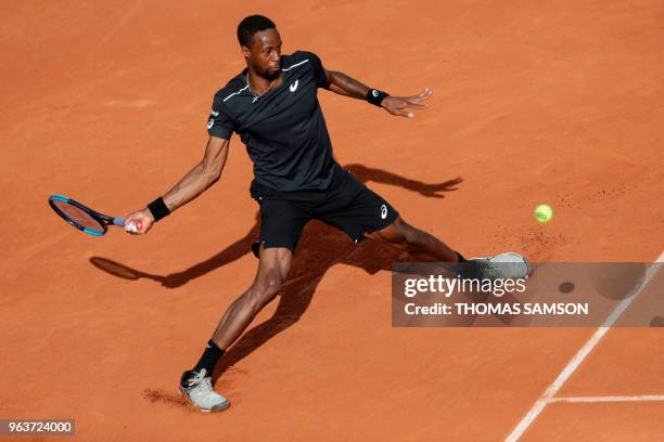 France's Gael Monfils returns the ball to Slovakia's Martin Klizan during their men's singles second round match on day four of The Roland Garros...