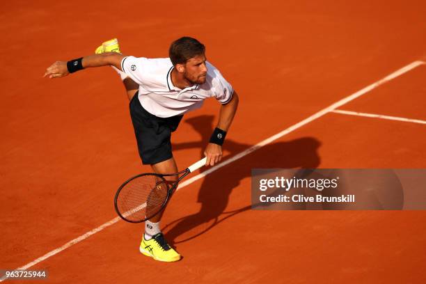 Martin Klizan of Slovakia serves during his mens singles second round match against Gael Monfils of France during day four of the 2018 French Open at...