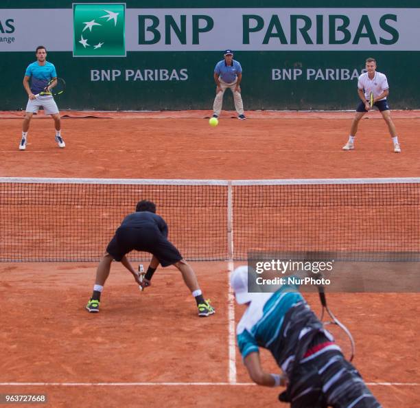 Lukasz Kubot of Poland and Marcelo Melo of Brazil serves against Márton Fucsovics of Hungary and Marco Cecchinato of Italy during the second round at...