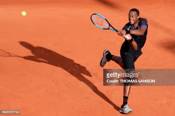 France's Gael Monfils returns the ball to Slovakia's Martin Klizan during his men's singles second round match, on day four of The Roland Garros 2018...