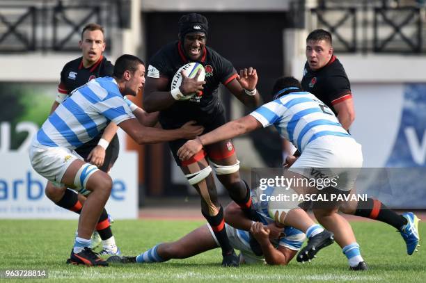 England prop Joel Kpoku breaks away from Argentina's players during the U20 World Rugby Championship match between England and Argentina at Parc des...