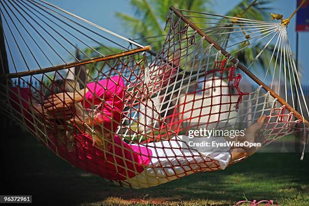 Woman lying in a hammock and working with a notebook on January 12, 2010 in Varkala near Trivandrum, Kerala, India.
