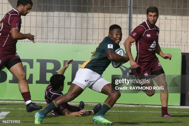 South Africa's center Lasha Lomidze runs for a try despite Georgia's defence during the Under 20 Rugby union World Cup at the Aime Giral stadium in...