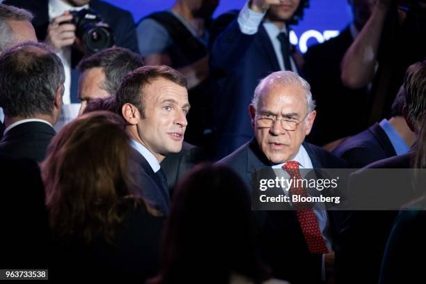 Emmanuel Macron, France's president, left, speaks with Jose Angel Gurria, secretary-general of the Organization for Economic Cooperation and...