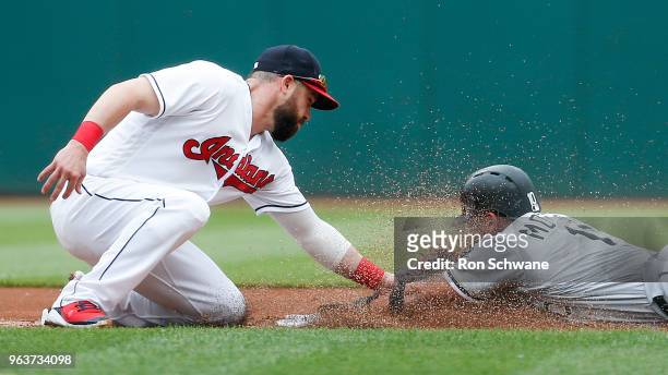 Jason Kipnis of the Cleveland Indians tags out Yoan Moncada of the Chicago White Sox attempting to steal second base during the first inning at...