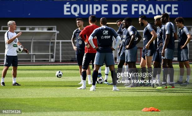 France's head coach Didier Deschamps gives instructions to players during a training session in Clairefontaine en Yvelines on May 30 as part of the...