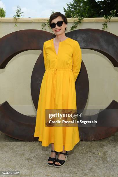 Kristin Scott Thomas poses at a photocall prior the Chanel Opening Party for the Exhibition "Dans les Champs de Chanel" at Jardin des Tuileries on...