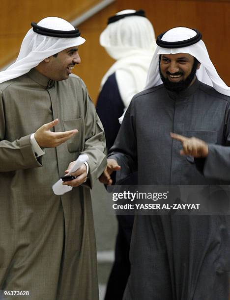 Kuwaiti MPs Khaled al-Adwa and Khaled al-Tahous attend a parliament session at the national assembly hall in Kuwait City on February 3, 2010....