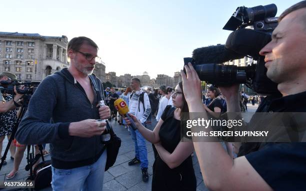 Ukrainian Journalists, who originally rallied at Independence Square in Kiev to mourn anti-Kremlin journalist Arkady Babchenko, celebrate after he...