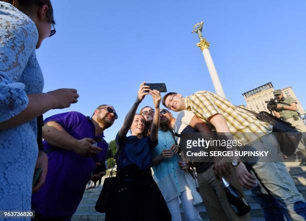 Ukrainian Journalists, who originally rallied at Independence Square in Kiev to mourn anti-Kremlin journalist Arkady Babchenko, celebrate after he...