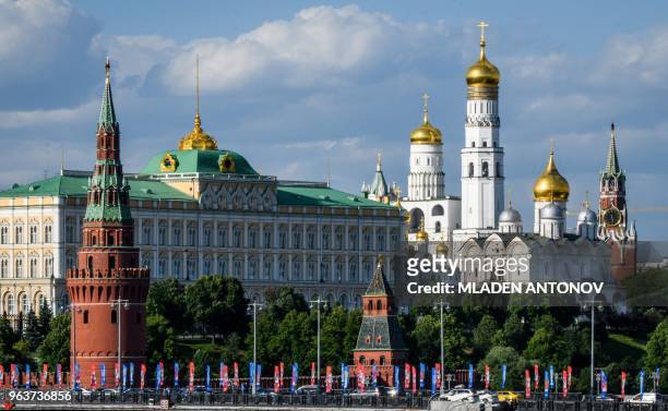 Photograph taken on May 30, 2018 shows a bridge decorated with FIFA World Cup 2018 flags in front of the Kremlin in Moscow. - The FIFA World Cup 2018...