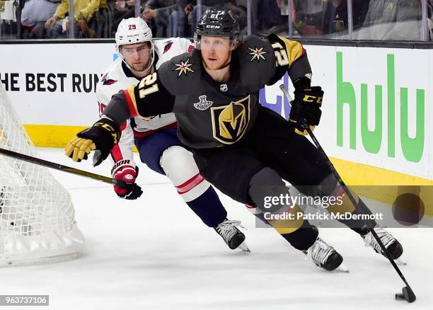 Cody Eakin of the Vegas Golden Knights is chased by Christian Djoos of the Washington Capitals during the third period of Game One of the 2018 NHL...