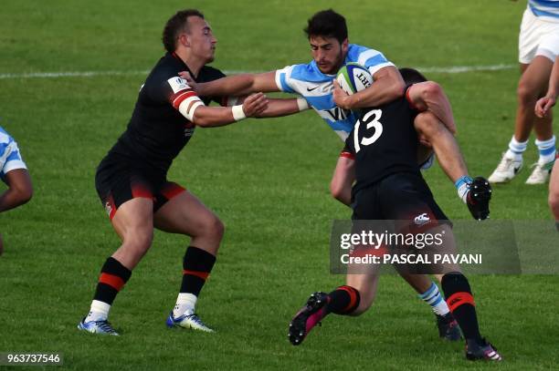 Argentina's winger Pablo Avellaneda collapses with England's fly half Tom Hardwick and England centre Fraser Dingwall during the U20 World Rugby...