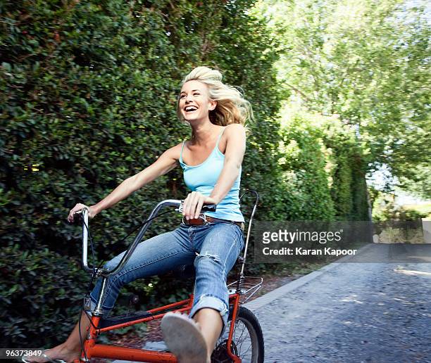 young female on copper cycle - radfahren stock-fotos und bilder