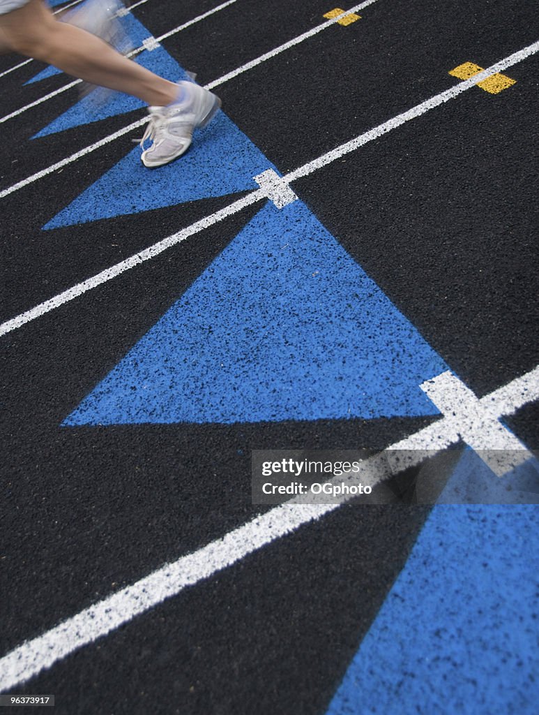 Runner on a black track.