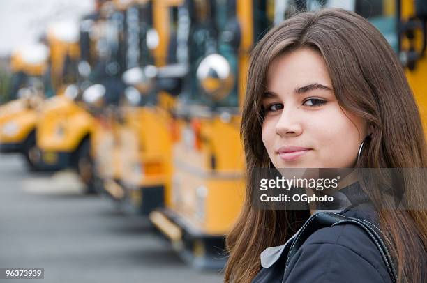teenage girl getting  on a yellow school bus. - ogphoto bildbanksfoton och bilder
