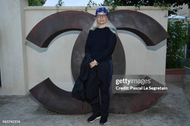 Dominique Issermann poses at a photocall prior the Chanel Opening Party for the Exhibition "Dans les Champs de Chanel" at Jardin des Tuileries on May...