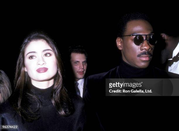 Actress Charlotte Lewis and actor Eddie Murphy attend the premiere of "The Golden Child" on December 11, 1986 at the Loew's Astor Plaza Theater in...