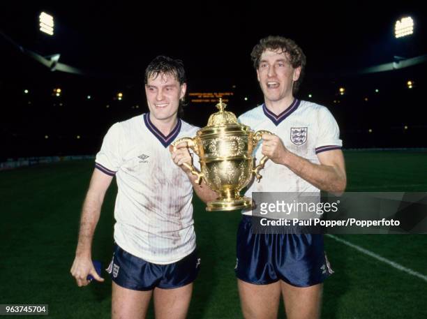 Glenn Hoddle and Terry Butcher of England celebrate with the trophy after the Rous Cup match between England and Scotland at Wembley Stadium on April...
