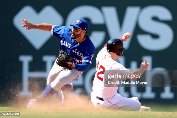 Brock Holt of the Boston Red Sox steals second past Devon Travis of the Toronto Blue Jays during the eighth inning at Fenway Park on May 30, 2018 in...