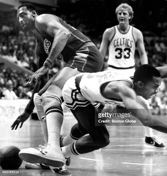 Boston Celtics' Gerald Henderson, right, falls to the floor after being tripped by the Bucks' Bob Lanier, left, as Celtics' Larry Bird looks toward a...