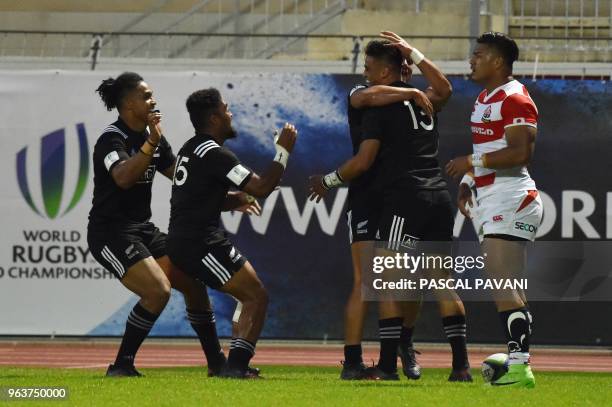 New Zeland centre Bailyn Sullivan celebrates with team mates after scoring a try during the World union Rugby U20 Championship match between...