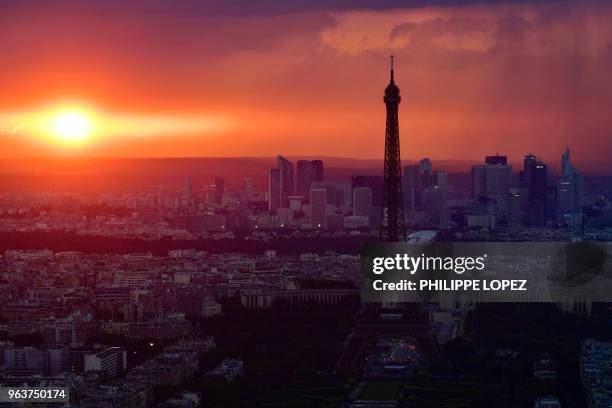 Picture taken on May 30, 2018 from the observatory deck of the Montparnasse tower in Paris shows the Eiffel Tower in Paris and La Defense business...