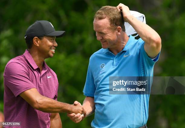 Tiger Woods and Peyton Manning shake hands after their Pro-Am round prior to the Memorial Tournament presented by Nationwide at Muirfield Village...