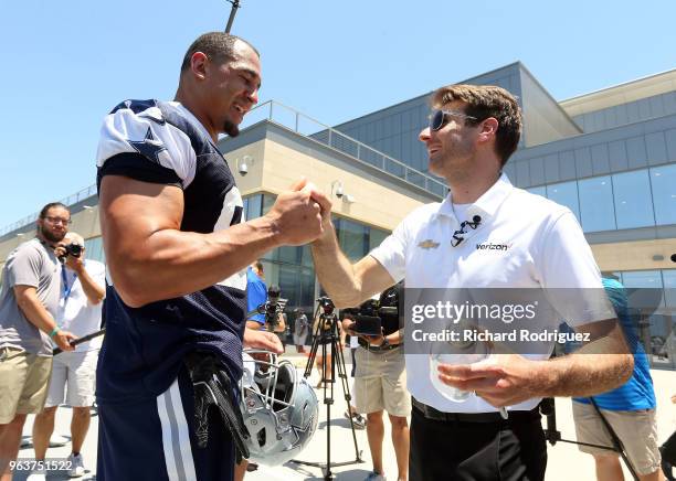 Dallas Cowboys defensive lineman Tyrone Crawford meets Indianapolis 500 Champion Will Power after practice at The Ford Center at The Star on May 30,...