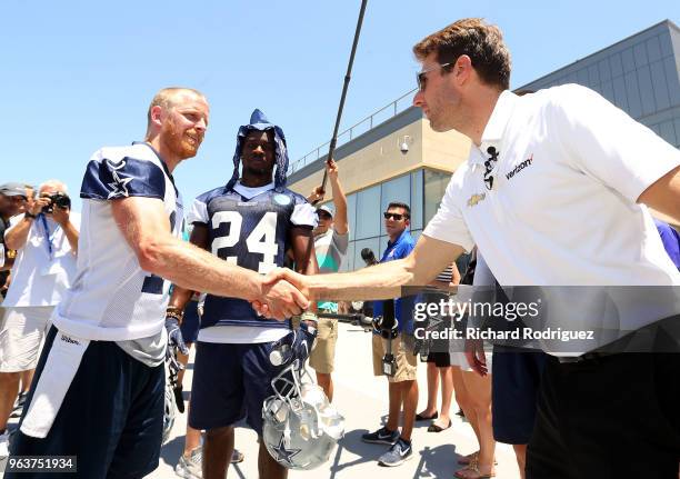 Dallas Cowboys wide reciever Cole Beasley shakes hands with Indianapolis 500 Champion Will Power after practice at The Ford Center at The Star on May...