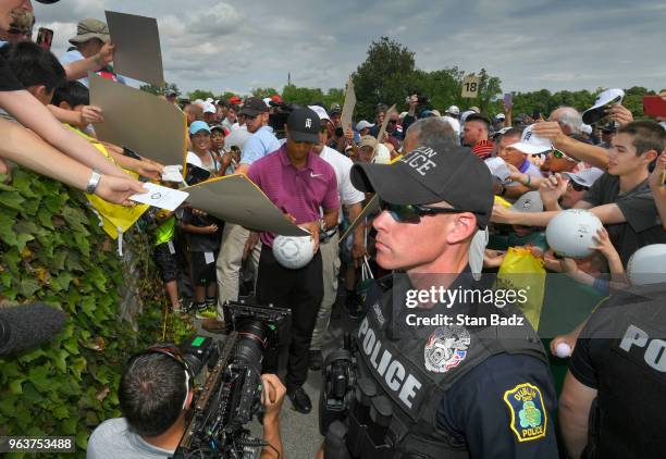 Tiger Woods signs autographs for fans after the Pro-Am round to the Memorial Tournament presented by Nationwide at Muirfield Village Golf Club on May...