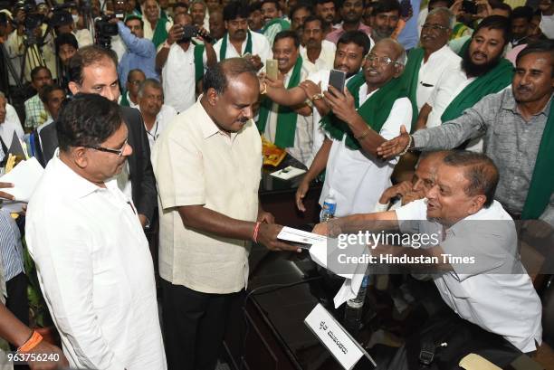 Karnataka chief minister H D Kumarswamy and his deputy G Parameshwara attend a meeting with farmer leaders at Vidhan Soudha on May 30, 2018 in...