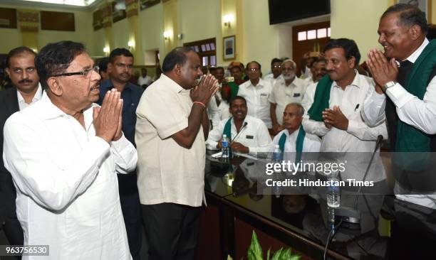 Karnataka chief minister H D Kumarswamy and his deputy G Parameshwara attend a meeting with farmer leaders at Vidhan Soudha on May 30, 2018 in...