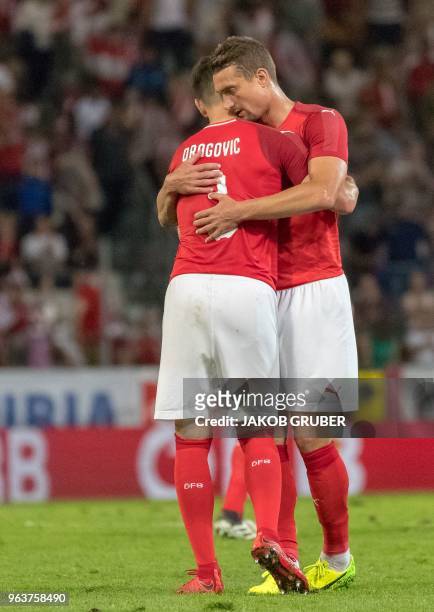 Austrian players Aleksandar Dragovic and Stefan Ilsanker celebrate their victory 1:0 during their international friendly football match between...