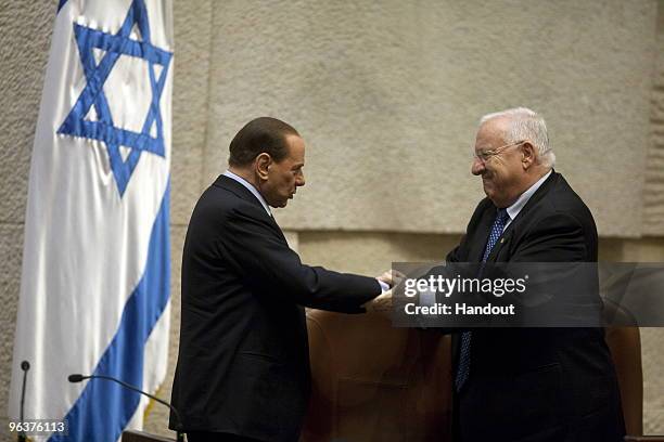 Italian Prime Minister Silvio Berlusconi shakes hands with Israel's Speaker of the Parliament Reuven Rivlin after delivering a speech in the Knesset...