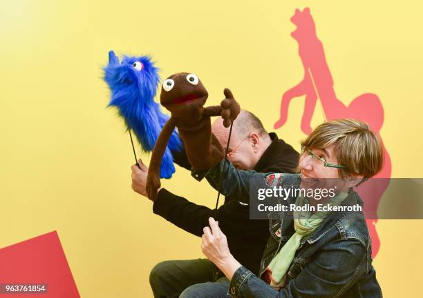 Attendee Rocio Ayuso practices puppeteering at the press preview of The Jim Henson Exhibition: Imagination Unlimited at Skirball Cultural Center on...