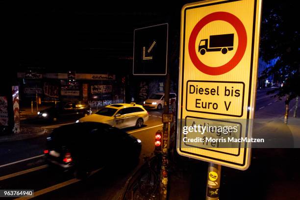 Car pass a sign that bans access for older-model diesel cars on a street on May 30, 2018 in Hamburg, Germany. The city is launching the project on...