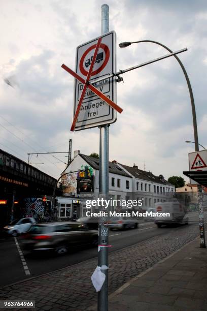 Cars pass an invalid sign that bans access for older-model diesel cars on a street on May 30, 2018 in Hamburg, Germany. The city is launching the...