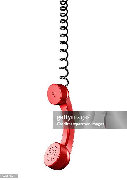 red hanging telephone receiver on a spiral cord  - am telefon stockfoto's en -beelden