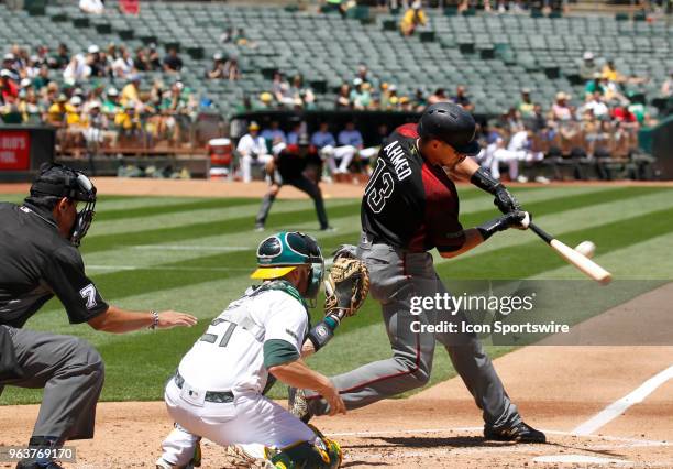 Arizona SS Nick Ahmed puts the ball in play during the inter-league game between the Arizona Diamondbacks and the Oakland A's played on May 27, 2018...