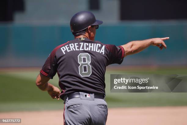 Arizona 3B Coach Tony Perezchica signals a runner in the inter-league game between the Arizona Diamondbacks and the Oakland A's played on May 27,...