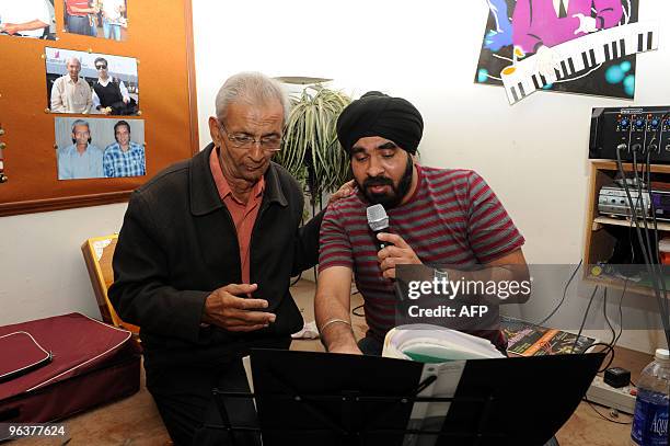 Indian music teacher Rajubhai Vyas teaches at the Rajpath Club Music Room in Ahmedabad February 3, 2010 the eve of World Cancer Day. Vyas underwent...