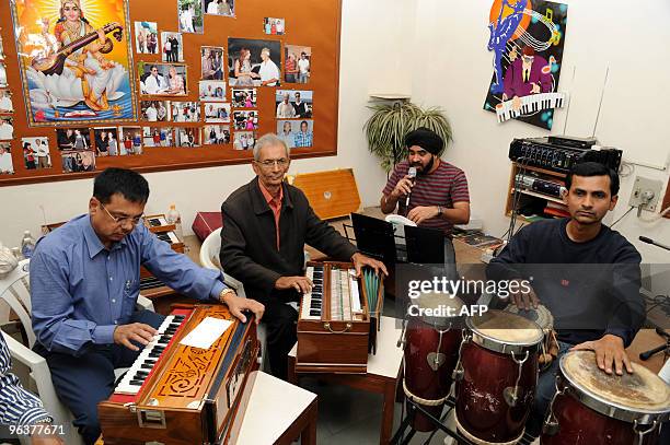 Indian music teacher Rajubhai Vyas teaches at the Rajpath Club Music Room in Ahmedabad February 3, 2010 the eve of World Cancer Day. Vyas underwent...