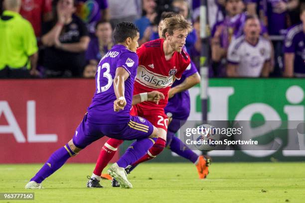 Chicago Fire midfielder Daniel Johnson and Orlando City defender Mohamed El-Munir go for the ball during the soccer match between the Orlando City...