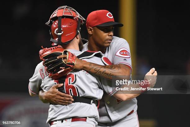 Tucker Barnhart and Raisel Iglesias of the Cincinnati Reds celebrate after closing out the MLB game against the Arizona Diamondbacks at Chase Field...