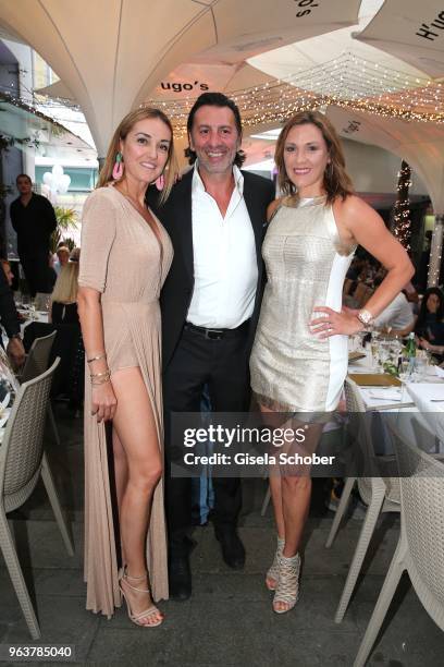 Melanie Fischer and her partner host Ugo Crocamo and Simone Ballack during the opening of H'ugo's Wine & Champagne bar on May 30, 2018 in Munich,...