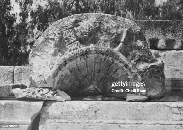 Scalloped piece of architecture from the doorway of the ancient synagogue at Capernaum in Galilee, circa 1930.