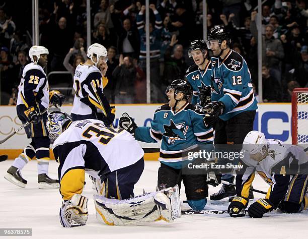 Joe Pavelski of the San Jose Sharks is congratulated by teammates Patrick Marleau and Marc-Edouard Vlasic after he made a goal on Ryan Miller of the...