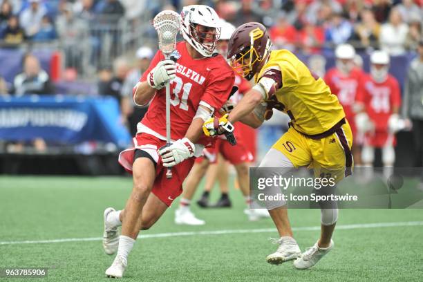 Wesleyan midfielder Taylor Ghesquiere tries to get past Salisbury midfielder Jeremiah LaClair on his way to the net. During the Wesleyan Cardinals...