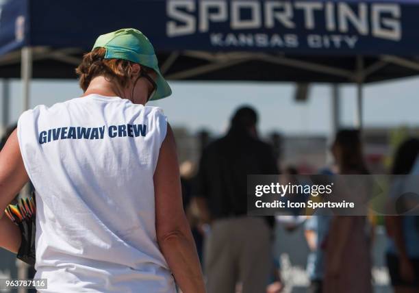 Giveaway crew member gets in position to distribute promotional items to fans before the MLS regular season match between Sporting Kansas City and...